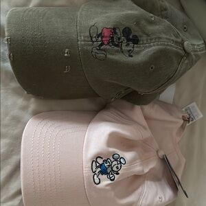 Disney hats. Sold together. Green worn once, pink never worn tag attached